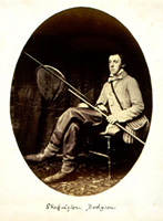Lewis Carroll's brother posing with a variety of fishing gear.